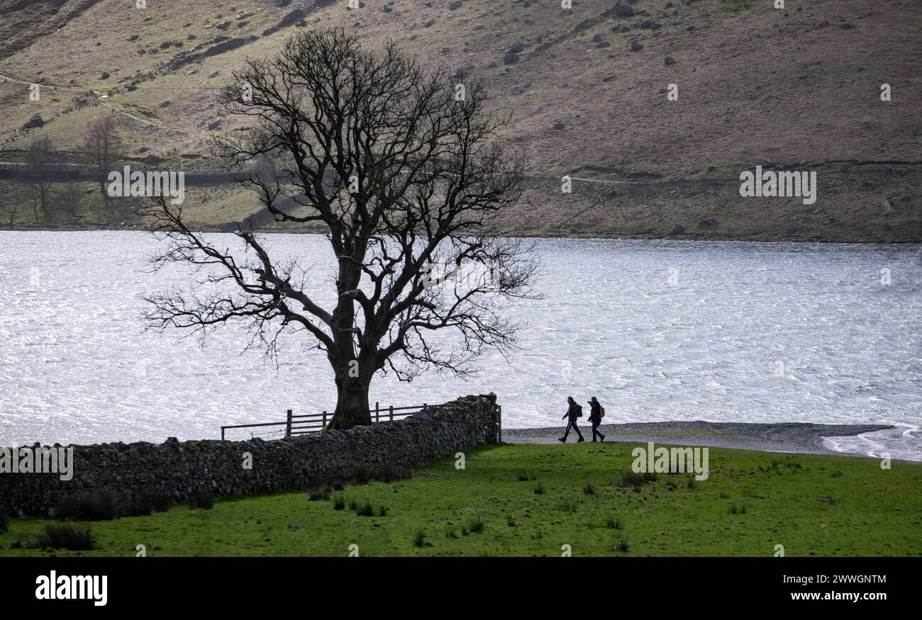 Walkers on the shore of Buttermere in the English Lake District on a spring morning, Cumbria, England. Stock Photo