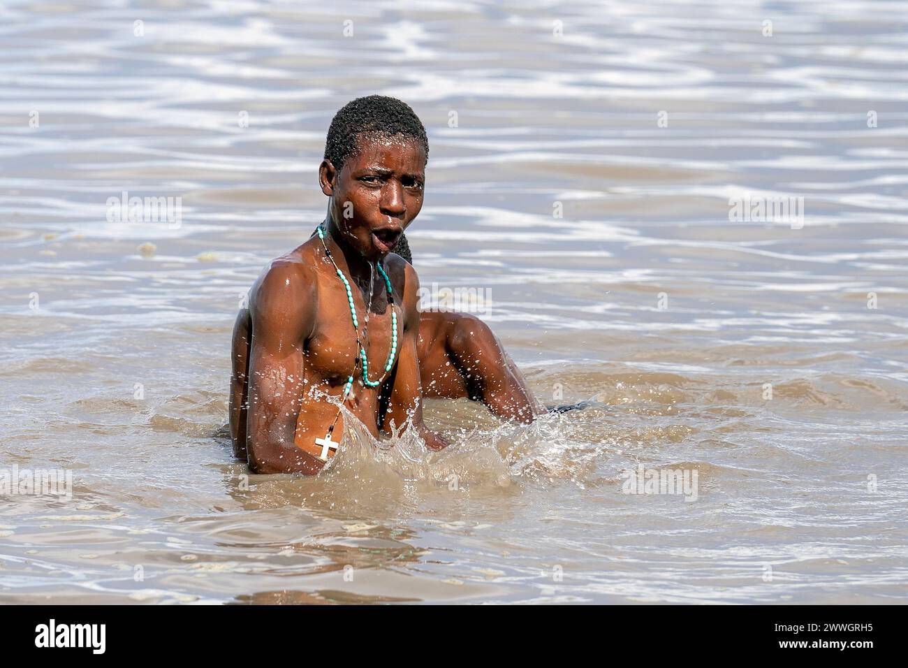 People swim in the waters of Lake Chilwa in the Machinga district of Malawi. In 2015, the lake completely dried out because of climate change, which led to the loss of most species of fish, putting more pressure on another vital food source. Picture date: Tuesday March 5, 2024. Stock Photo