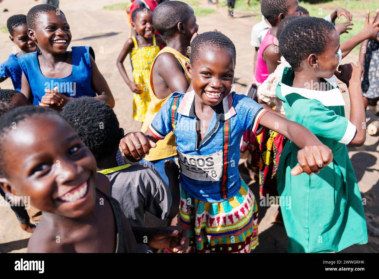 Children sing and dance in the flooding-prone regions around Lake Chilwa in the Machinga district of Malawi. In 2015, the lake completely dried out because of climate change, which led to the loss of most species of fish, putting more pressure on another vital food source. Picture date: Tuesday March 5, 2024. Stock Photo