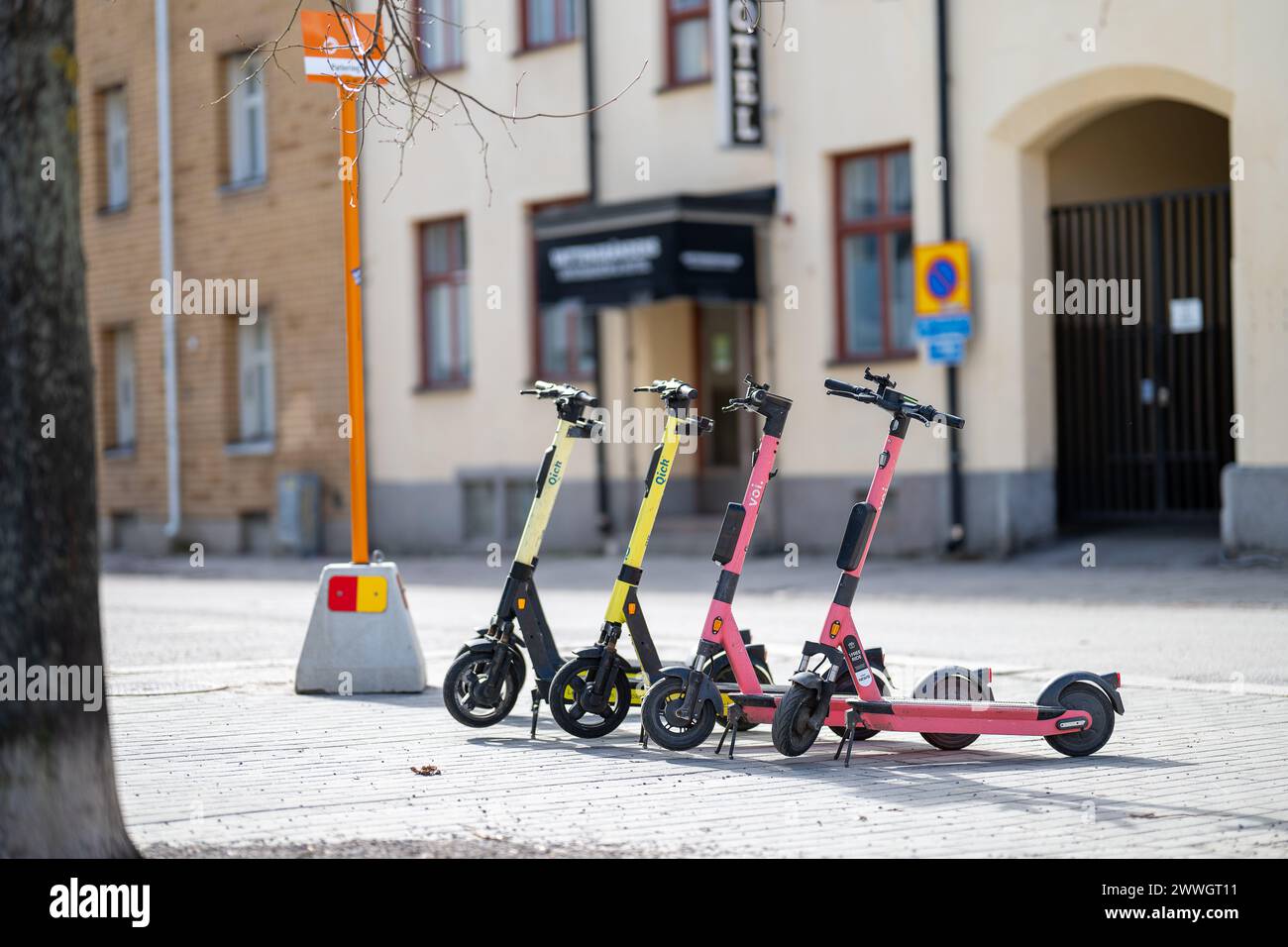 Electric scooters parked at a dedicated parking lot in Norrköping, Sweden. These vehicles are controversial and recently Paris voted for a ban. Stock Photo