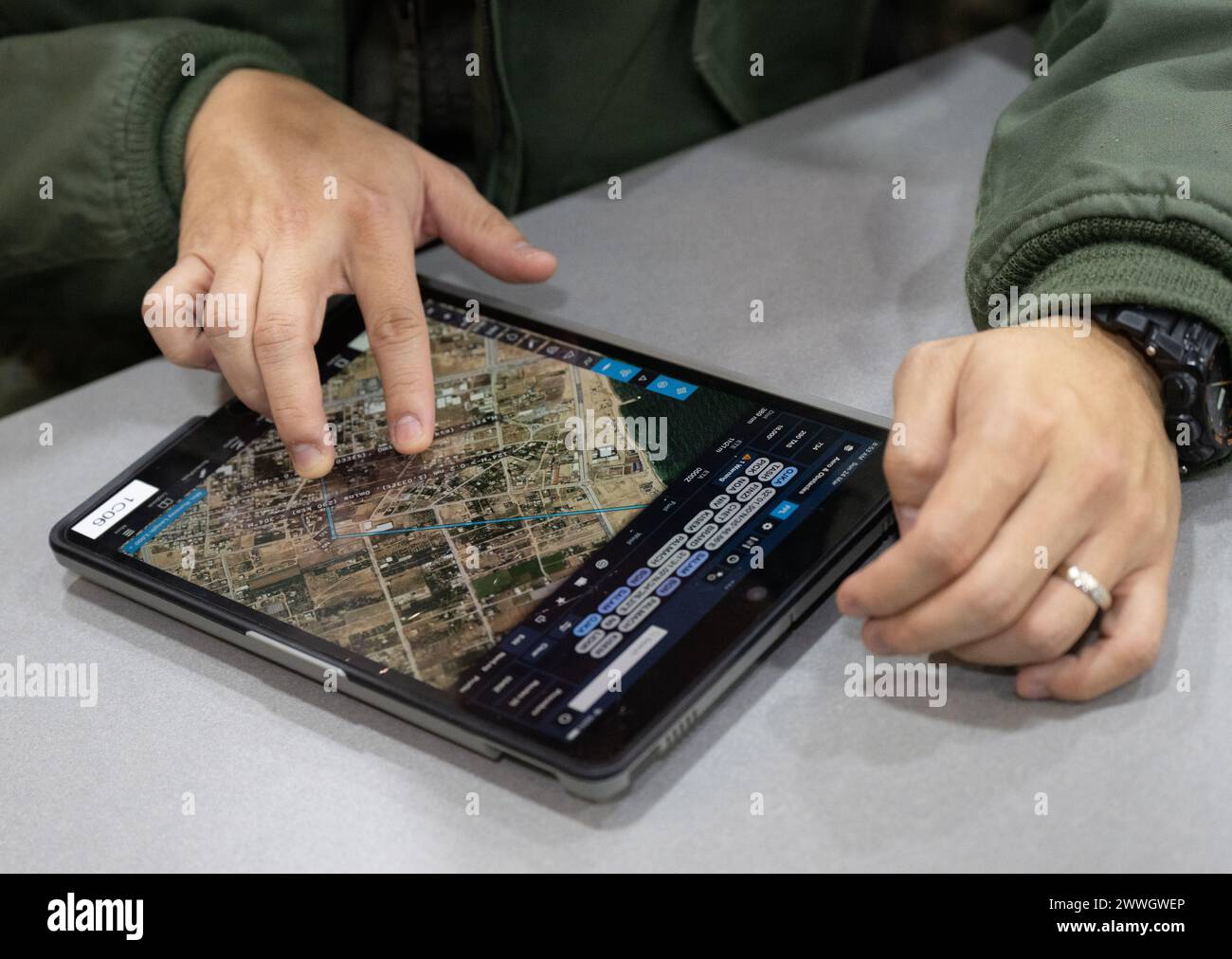 Amman, Jordan. 24th Mar, 2024. Pilots examine a map of Gaza on a tablet during a pilot briefing at an airbase in Jordan in order to locate the drop point for aid supplies. Credit: Boris Roessler/dpa/Alamy Live News Stock Photo