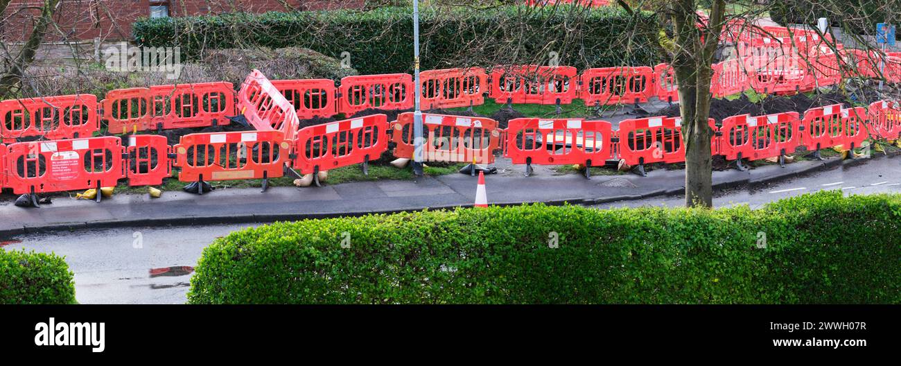Panorama view of protected roadworks on a suburban residential street UK Stock Photo
