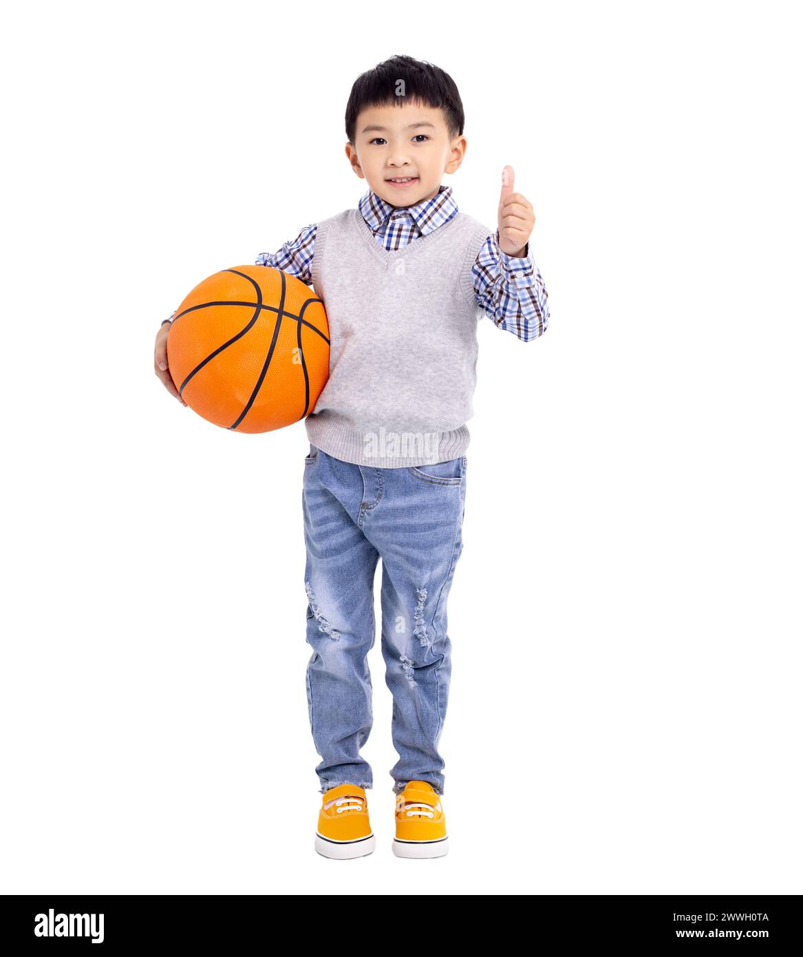 Happy asian Boy  holding a basketball and showing thumbs up isolated on white background Stock Photo