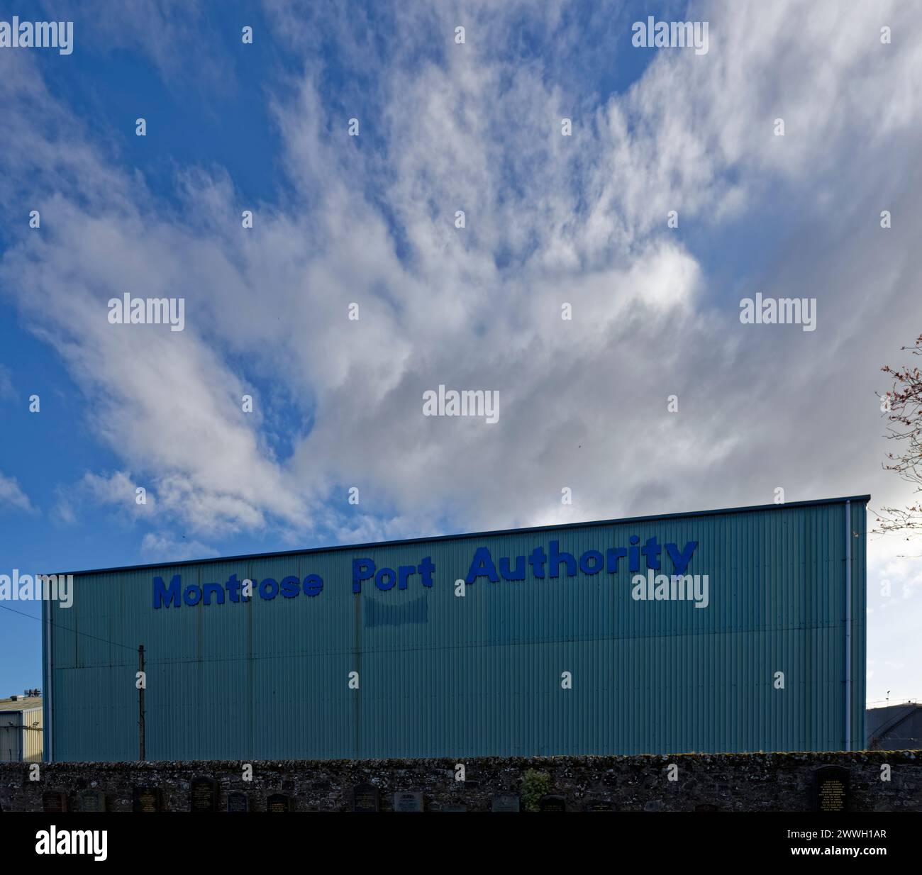 The side of a Galvanised steel clad Warehouse of the Montrose Port Authority on the perimeter of the Port Complex. Stock Photo