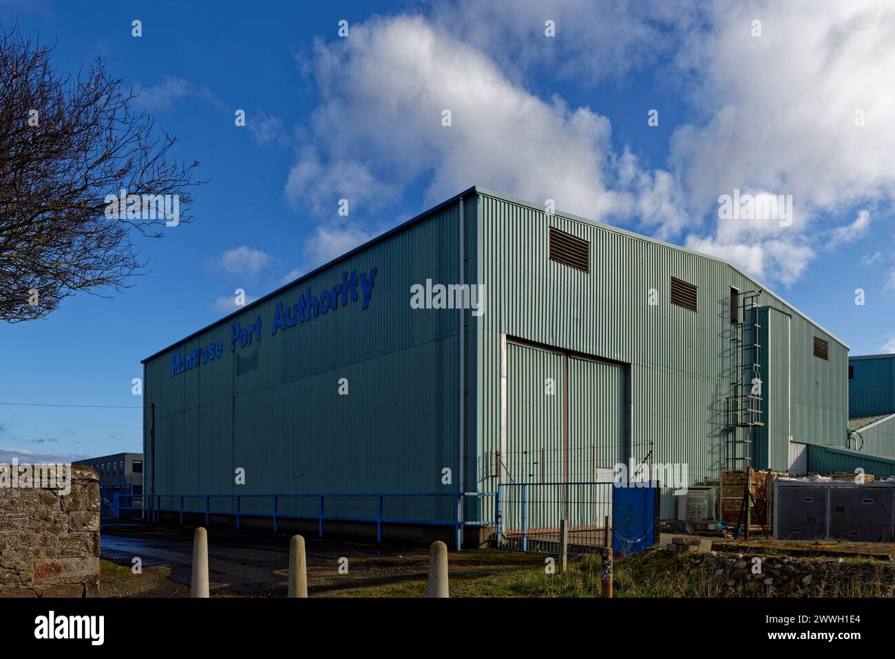 A Galvanised steel clad Warehouse of the Montrose Port Authority on the perimeter of the Port Complex, with its large double Hanger doors shut. Stock Photo