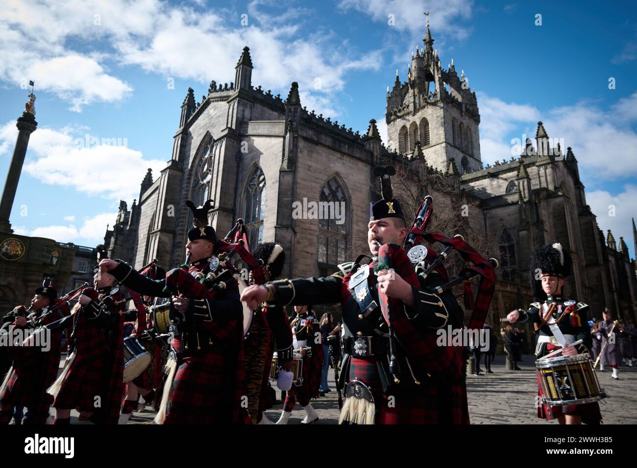 Edinburgh Scotland, UK 24 March 2024. The Royal Regiment Of Scotland (SCOTS), serving and veteran soldiers march down the Royal Mile from Edinburgh Castle Esplanade behind their Association standards, Pipes and Drums and the SCOTS Band for a short service at the Regimental Canongate Kirk to remember the fallen. credit sst/alamy live news Stock Photo