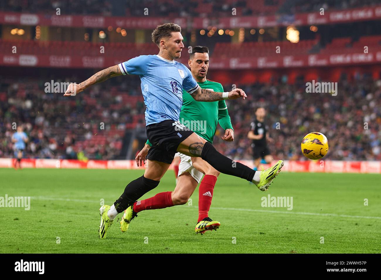 Bilbao, Spain. 23 March, 2024. Guillermo Varela of Uruguay compete for the ball with Dani Garcia of Pais Vasco during the Friendly Match Pais Vasco v Uruguay at Estadio de San Mames on March 23, 2024 in Bilbao, Spain. Credit: Cesar Ortiz Gonzalez/Alamy Live News Stock Photo