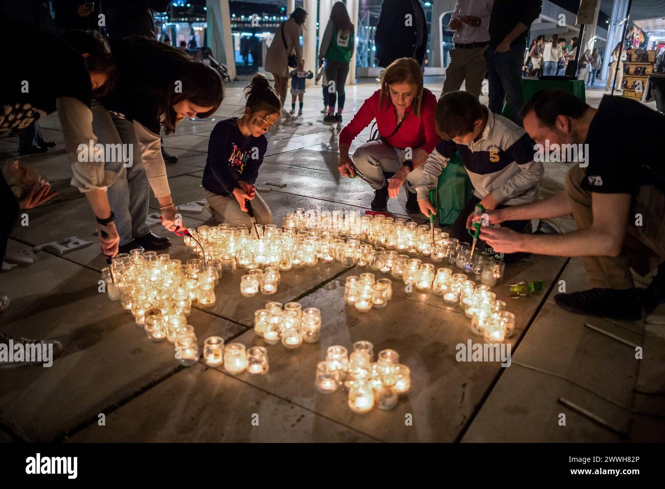 Members of the World Wildlife Foundation (WWF) are seen lighting candles of a mosaic that depicts a panda, the symbol of WWF, during the Earth Hour in the centre of Malaga. The figure made with candles is a panda, the symbol of the WWF. Thousands of cities around the world switched off their electric lights during the Earth Hour to highlight the dangers of climate change. The figure made with candles is a panda, the symbol of the WWF. Thousands of cities worldwide switched off their electric lights during Earth Hour to highlight the dangers of climate change. Stock Photo
