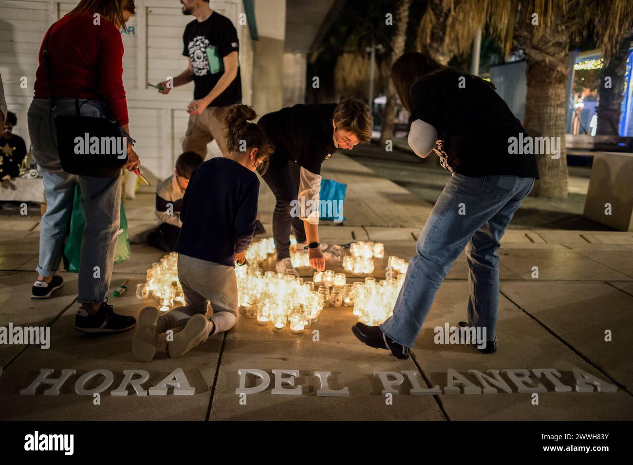 Members of the World Wildlife Foundation (WWF) are seen lighting candles of a mosaic that depicts a panda, the symbol of WWF, during the Earth Hour in the centre of Malaga. The figure made with candles is a panda, the symbol of the WWF. Thousands of cities around the world switched off their electric lights during the Earth Hour to highlight the dangers of climate change. The figure made with candles is a panda, the symbol of the WWF. Thousands of cities worldwide switched off their electric lights during Earth Hour to highlight the dangers of climate change. Stock Photo