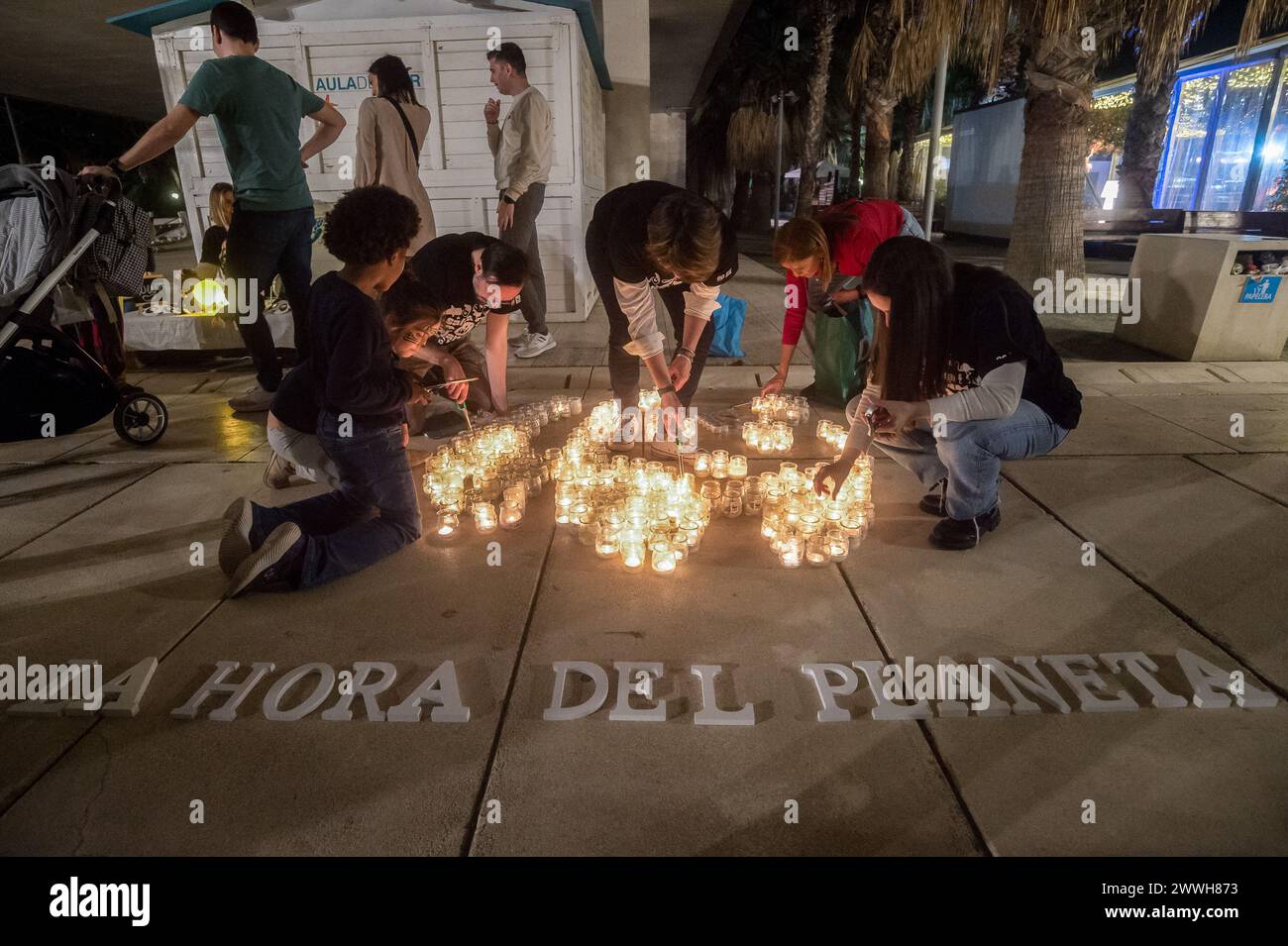 Members of the World Wildlife Foundation (WWF) are seen lighting candles of a mosaic that depicts a panda, the symbol of WWF, during the Earth Hour in the centre of Malaga. The figure made with candles is a panda, the symbol of the WWF. Thousands of cities around the world switched off their electric lights during the Earth Hour to highlight the dangers of climate change. The figure made with candles is a panda, the symbol of the WWF. Thousands of cities worldwide switched off their electric lights during Earth Hour to highlight the dangers of climate change. (Photo by Jesus Merida/SOPA Imag Stock Photo