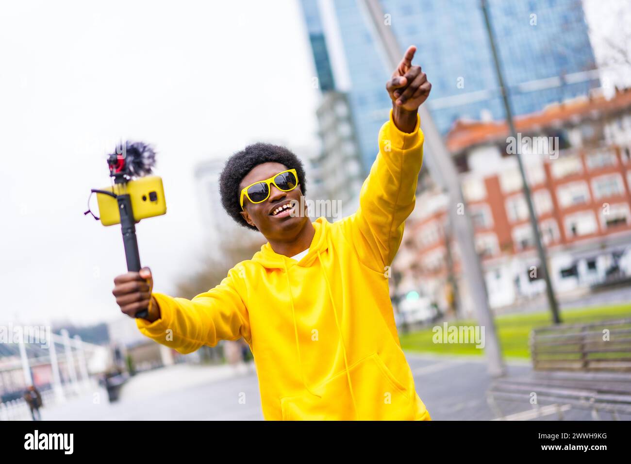 African cool young vlogger pointing ahead during a live streaming in the city Stock Photo