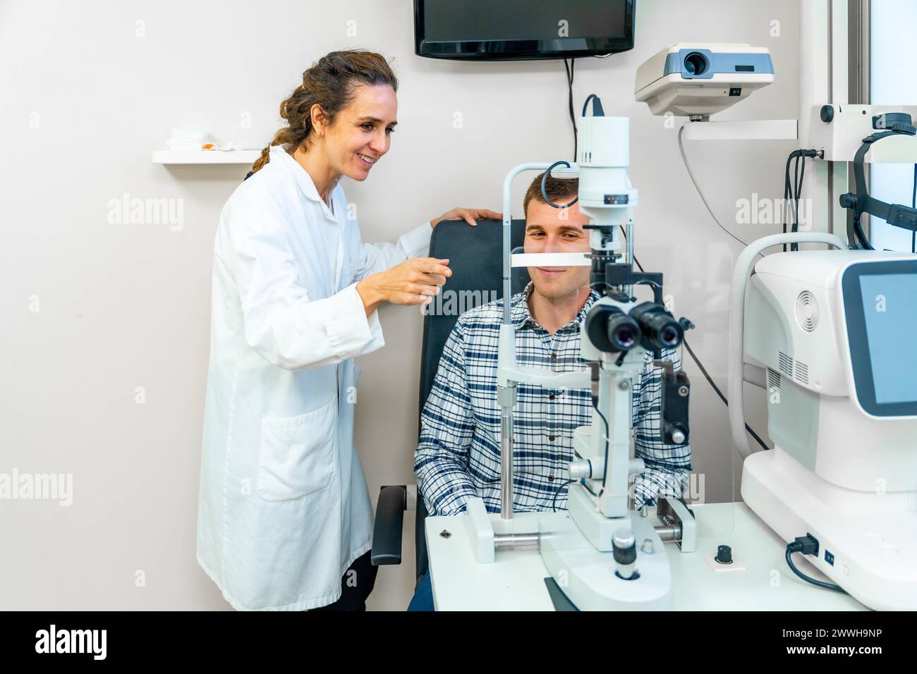 Horizontal photo of a man sitting doing a routine checkup in an ophthalmologist Stock Photo