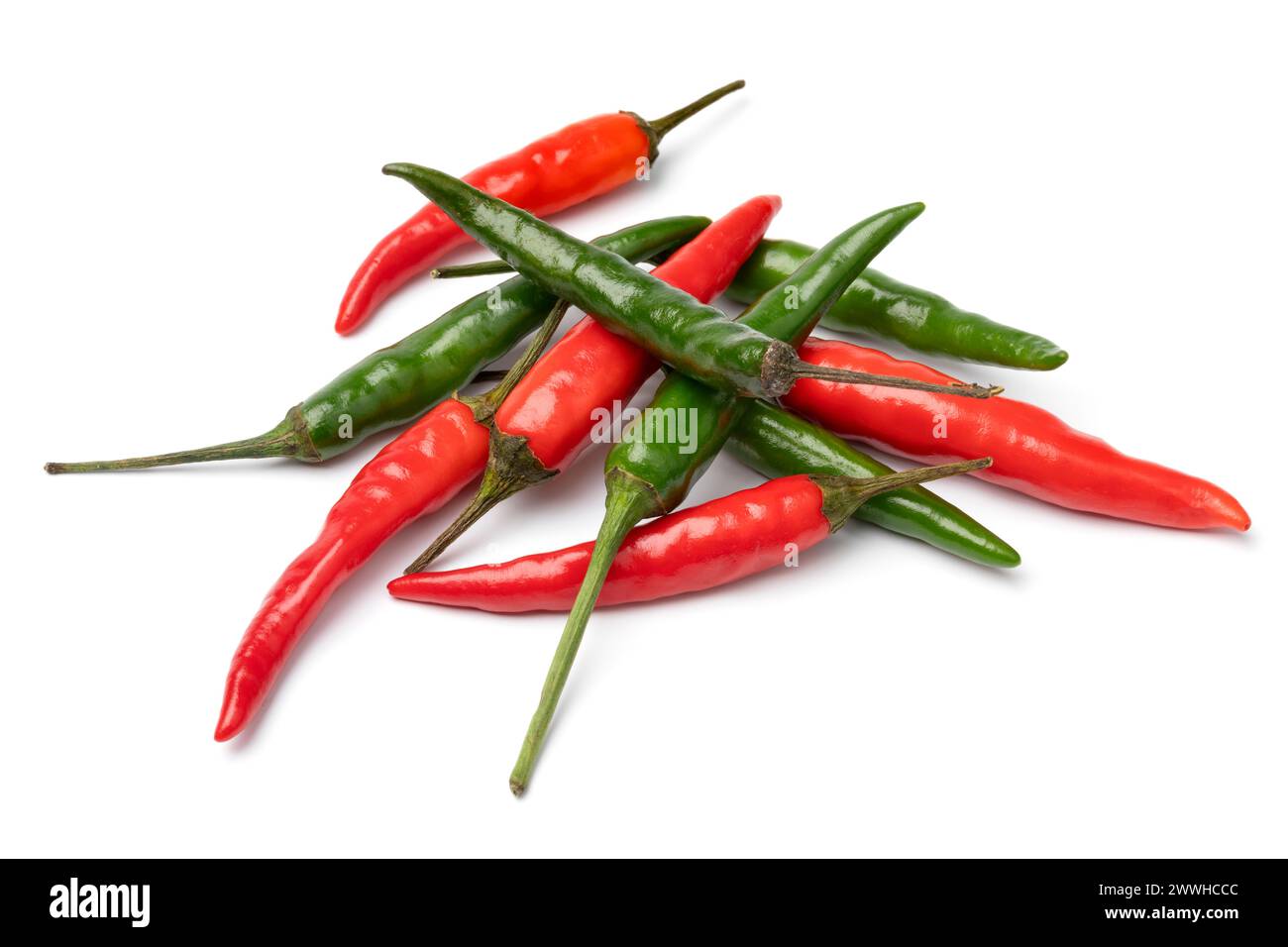 Heap of whole fresh raw green and red rawit peppers close up isolated on white background Stock Photo