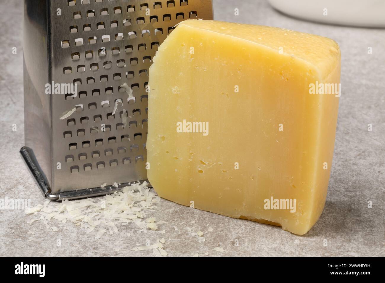 Piece of mature Italion Pecorino cheese and grater close up Stock Photo