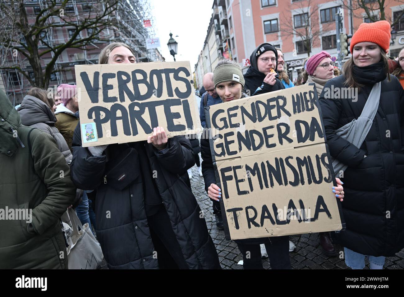 Munich, Germany. 24th Mar, 2024. Demonstrators hold placards with the words 'Verbotsartei' and 'Gender hier, Gender da, Feminismus trallala' during a demonstration against the gender ban on Gärtnerplatz. Credit: Felix Hörahger/dpa/Alamy Live News Stock Photo