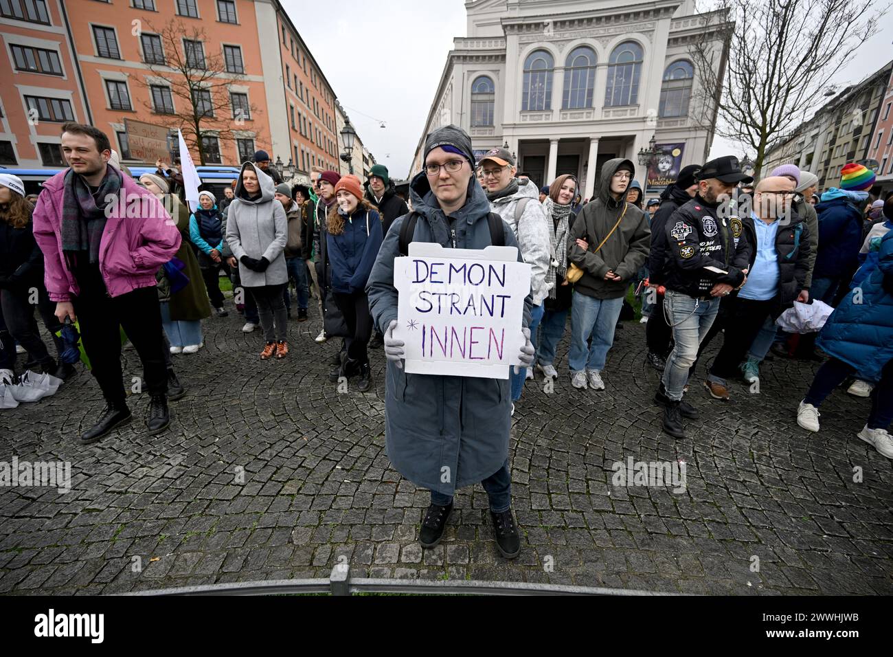 Munich, Germany. 24th Mar, 2024. A demonstrator holds a poster with the inscription 'Demonstrant*innen' during a demonstration against the gender ban on Gärtnerplatz. Credit: Felix Hörahger/dpa/Alamy Live News Stock Photo