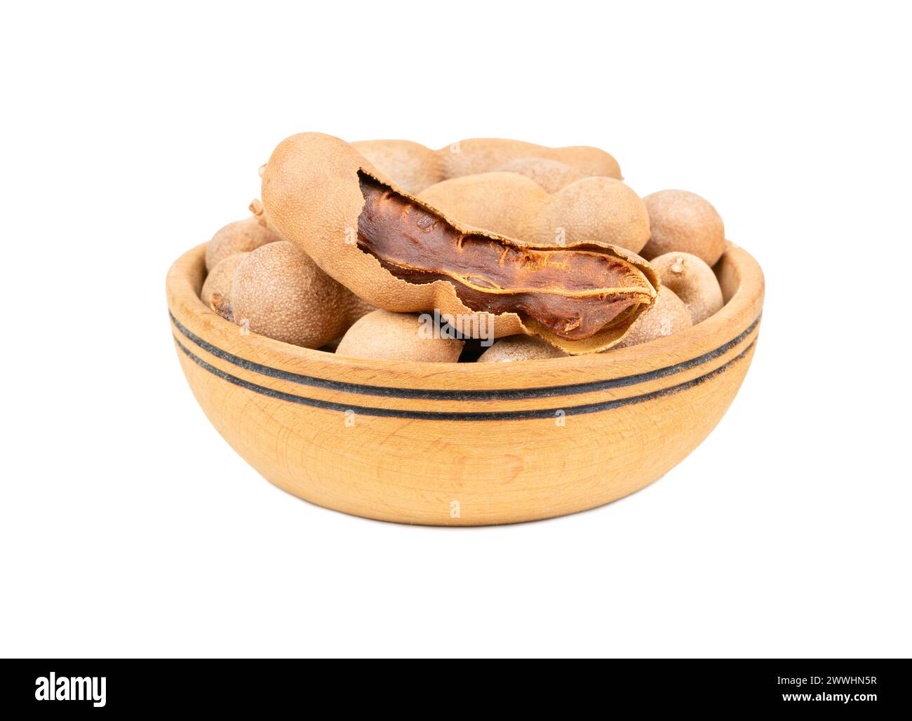 Tamarind fruit in wooden bowl isolated on white background Stock Photo