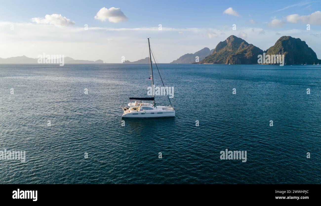 Aerial drone view of sailing yacht anchored in the bay with clear and ...