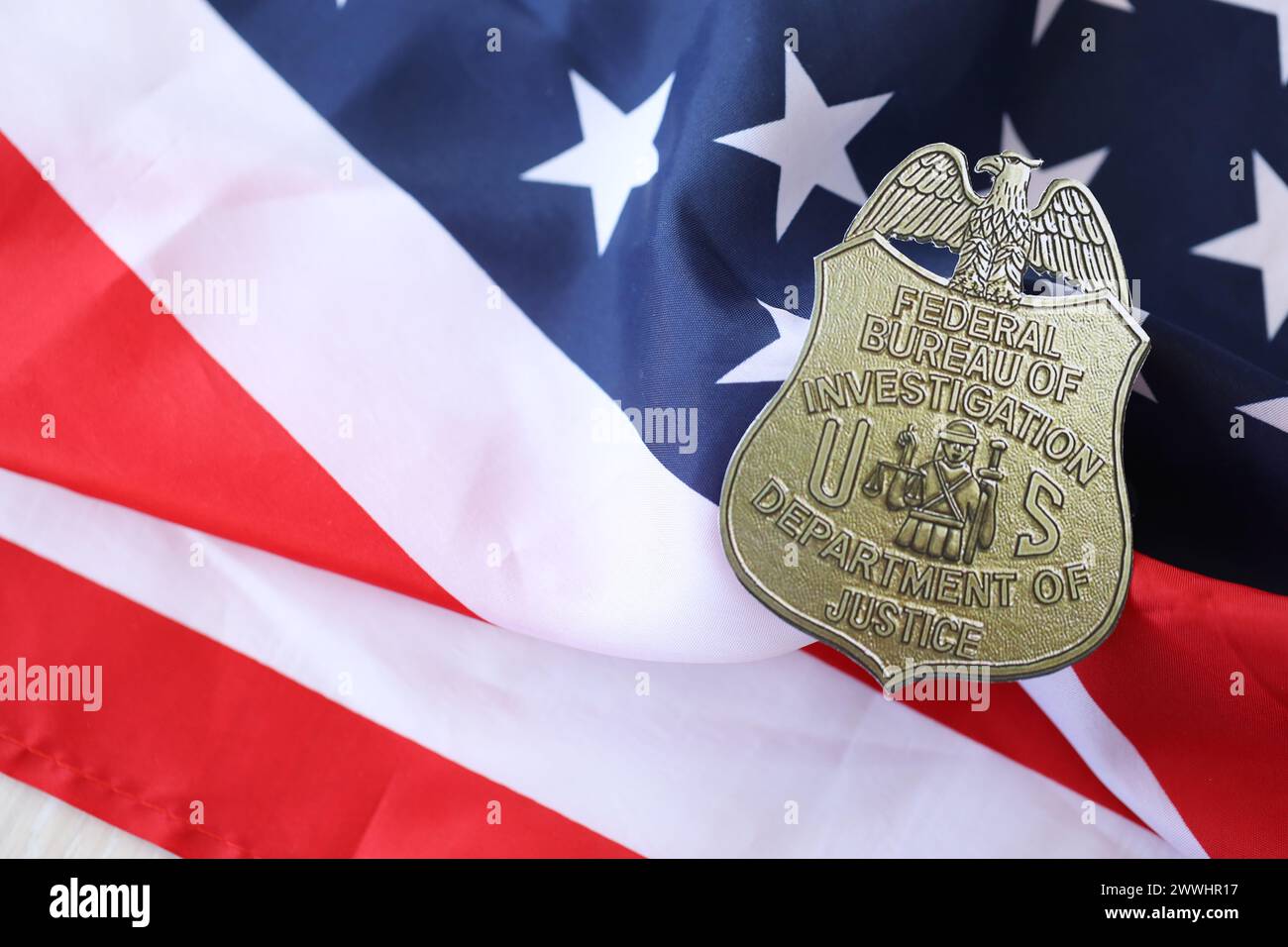 KYIV, UKRAINE - MARCH 9, 2024 US FBI Federal Bureau of Investigation badge on United States of America flag close up Stock Photo