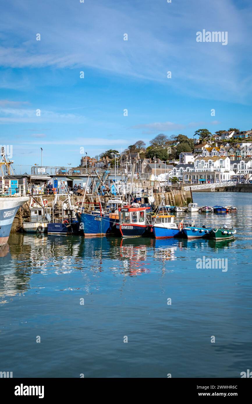 Brixham, UK. 24th Mar, 2024. A row of fishing trawlers moored, in order of size, in Brixham harbour. Credit: Thomas Faull/Alamy Live News Stock Photo