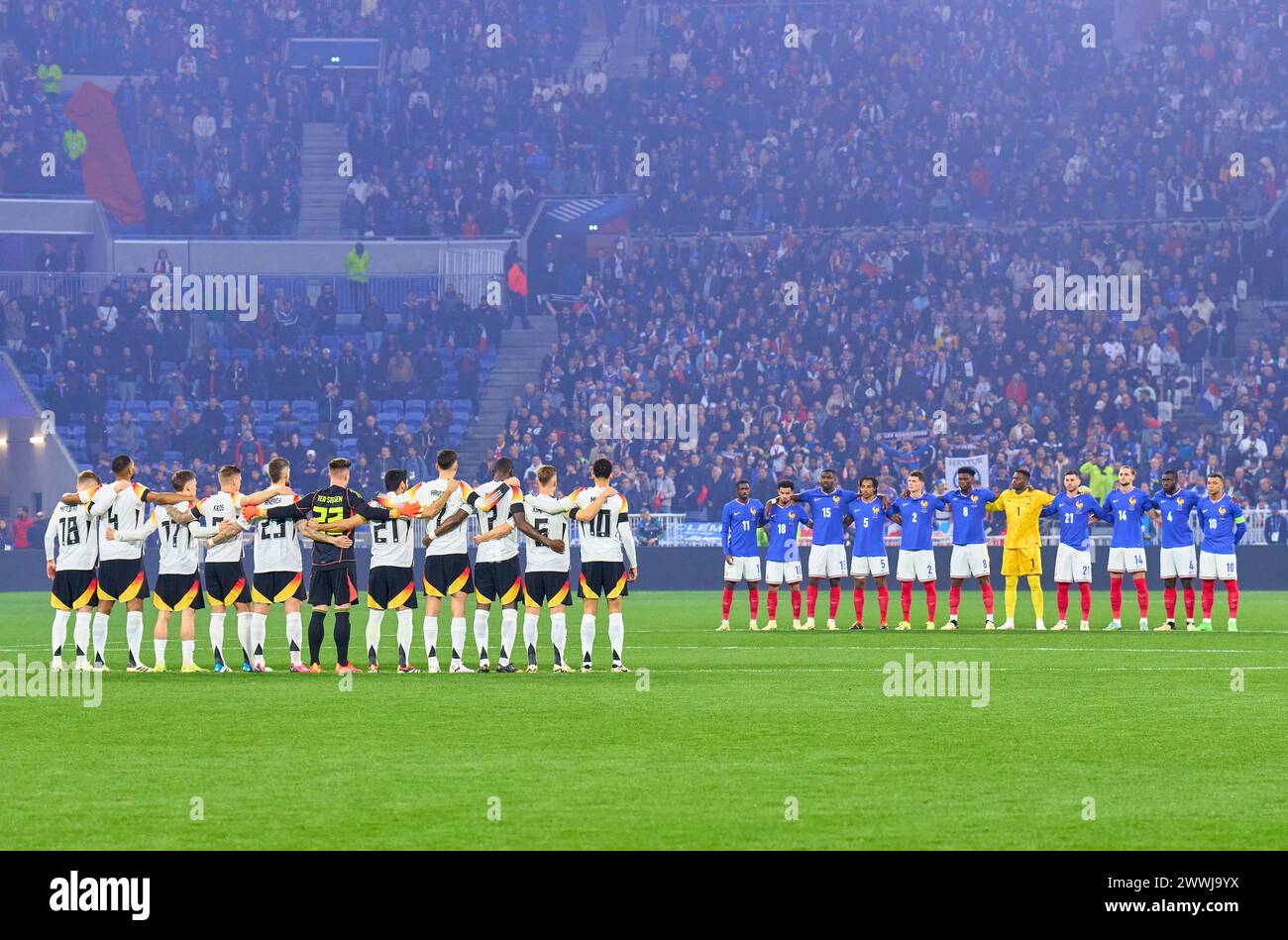 Team France and Germany in a memorial minute for the deceased former DFB player Andi Brehme and Franz Beckenbauer with Maximilian Mittelstädt, DFB 18 Jonathan Tah, DFB 4 Florian Wirtz, Nr. 17 DFB Toni Kroos, DFB 8 Robert Andrich, DFB 23 Marc-Andre ter STEGEN, DFB 22 Ilkay Gündogan, DFB 21 Kai Havertz, DFB 7 Antonio Rüdiger, Ruediger, DFB 2 Joshua Kimmich, DFB 6 Jamal Musiala, DFB 10  Brice Samba, FRA 1 goalkeeper, Benjamin Pavard, FRA 2 Dayot Upamecano, FRA 4 Jules Kounde, FRA 5 Aurelien Tchouameni, FRA 8 Kylian MBAPPE, FRA 10 Ousmane DEMBELE, FRA 11 Adrien Rabiot, FRA 14 Marcus Thuram, FRA 15 Stock Photo