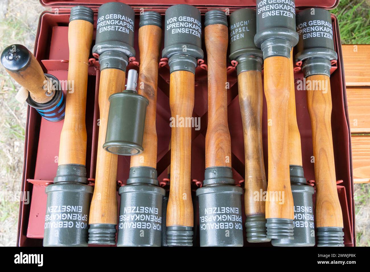 Wooden grip WWII hand grenades in an ammunition box Stock Photo