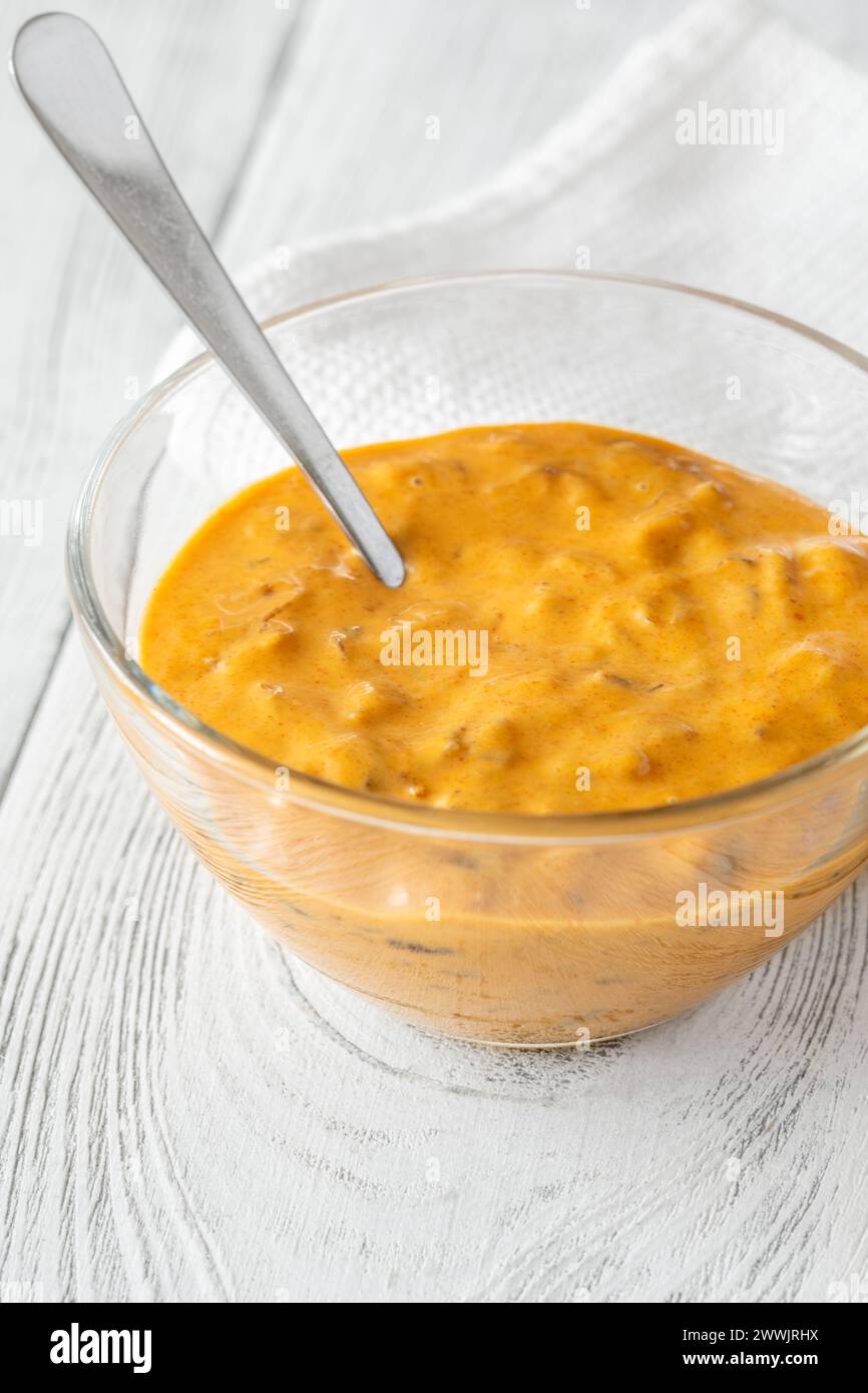 Glass bowl of burger sauce on the wooden table Stock Photo