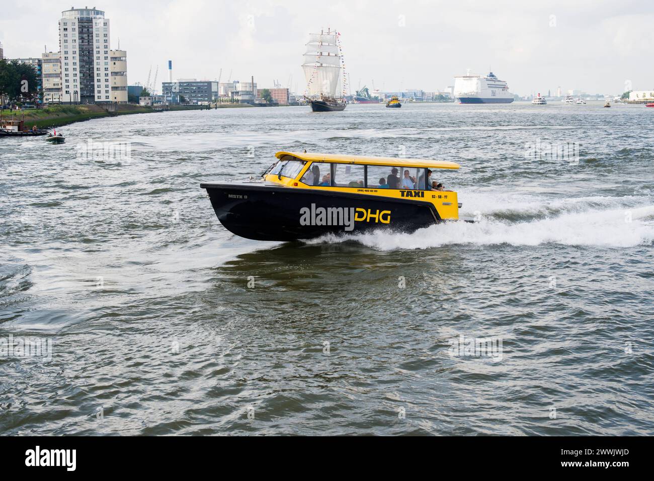 Water taxi racing by towards final destination Rotterdam, Netherlands. DHG Watertaxi racing to it s destination over the waters of Nieuwe Maas river, down town. Rotterdam Nieuwe Maas, nabij Wilhelminapie Zuid-Holland Nederland Copyright: xGuidoxKoppesx Stock Photo