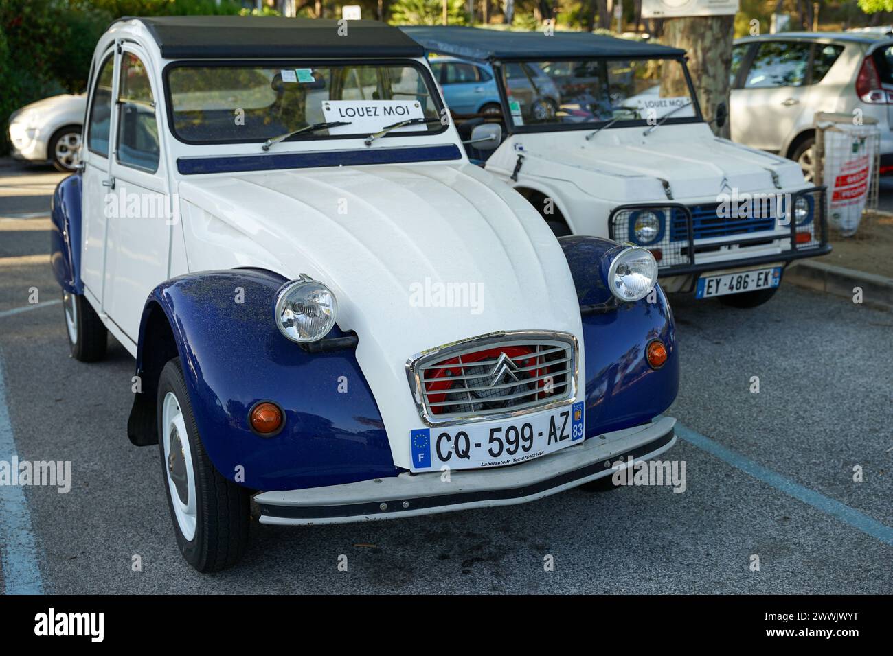 Le Lavandou, Provence, France - June 21 2021: Historic iconic car Citroen 2CV (duck) with blue and white colour parked in historic french riviera town Stock Photo