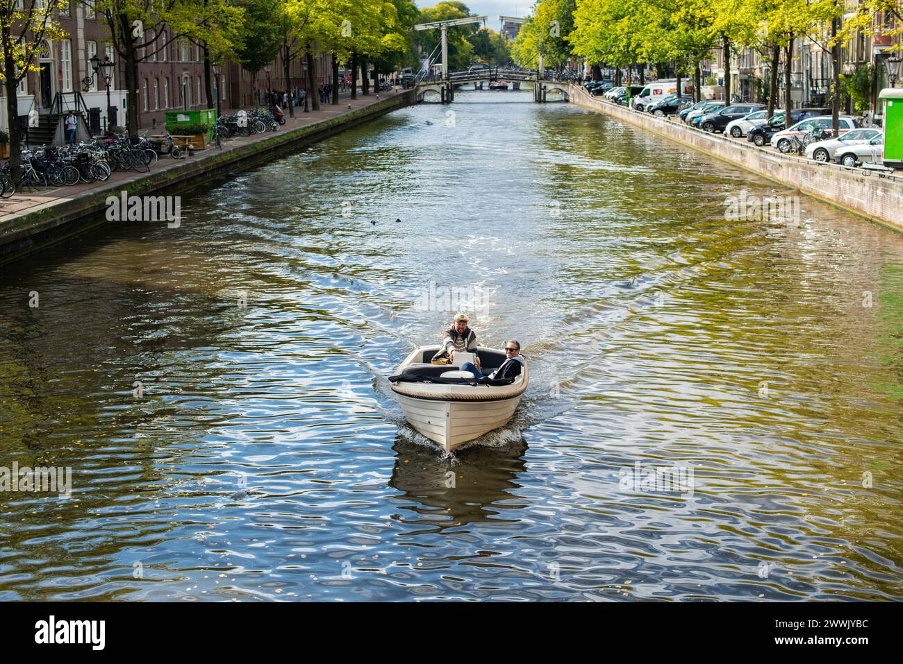 Little sloop with two men Amsterdam, Netherlands. Two mid adult men ...