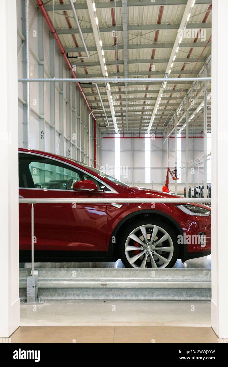 Tesla Model X A red colored Tesla Model X parked and recharging inside the factory warehosue. Tilburg Tesla Motors Noord-Brabant Nederkand Copyright: xGuidoxKoppesx Stock Photo
