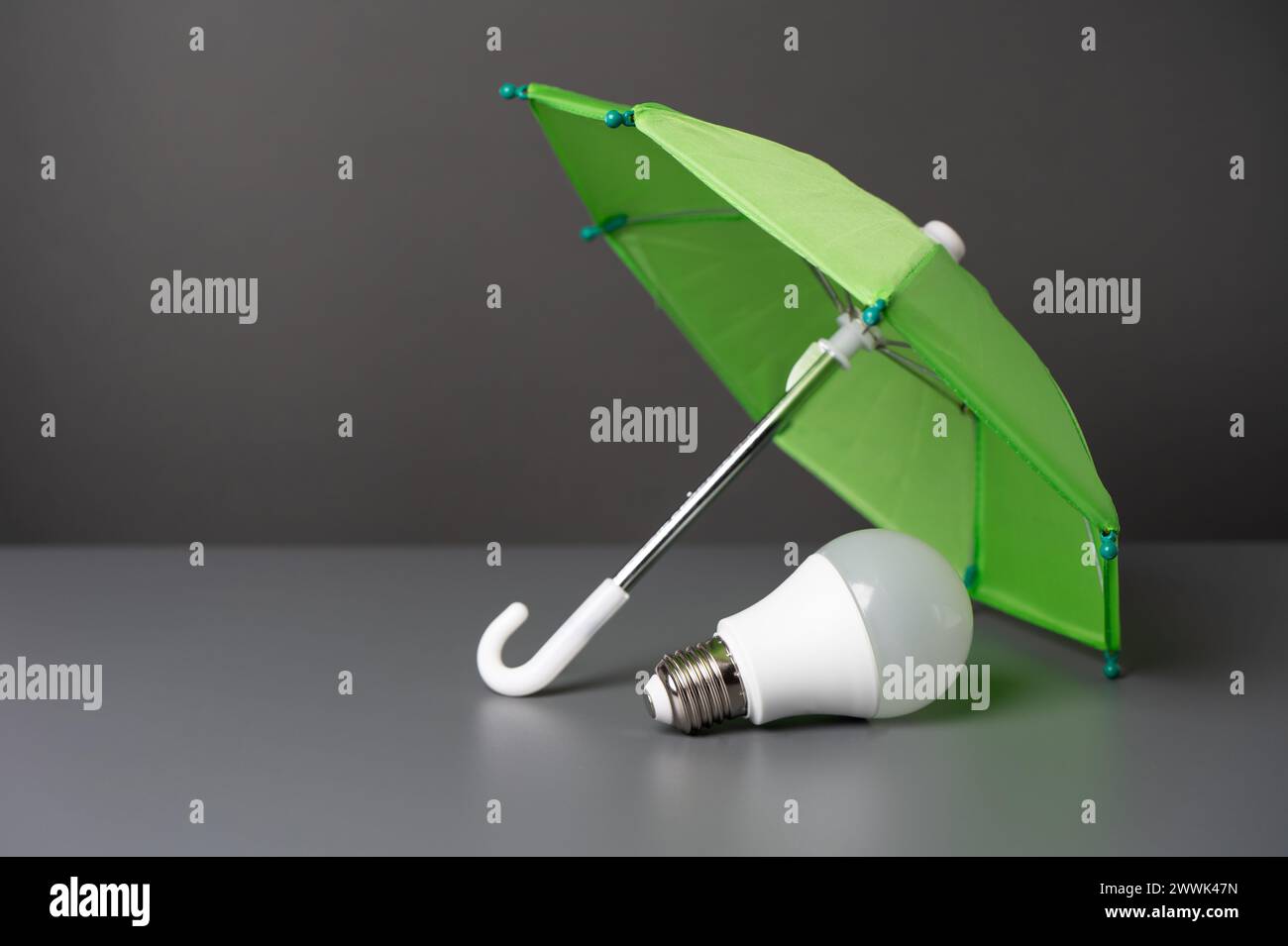 A light bulb idea under the insurance umbrella. Innovative solutions. Business insurance. Protection of copyright, patents and technologies. Stock Photo