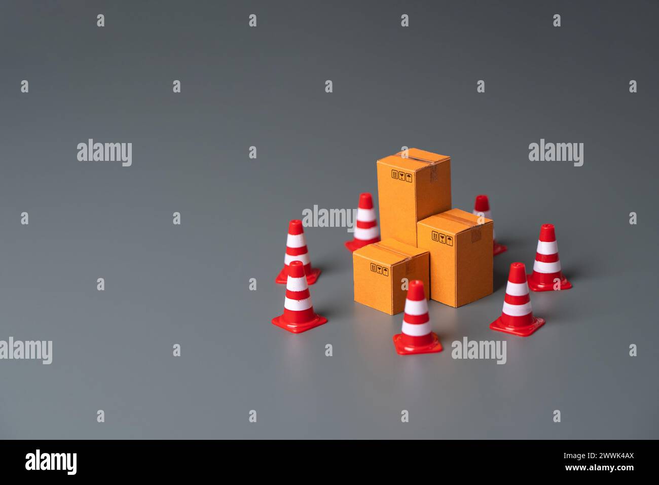 Boxes bounded by traffic cones. Cargo seizure and export restrictions. Economic impediments. Affecting economies and businesses, dependent on the unin Stock Photo
