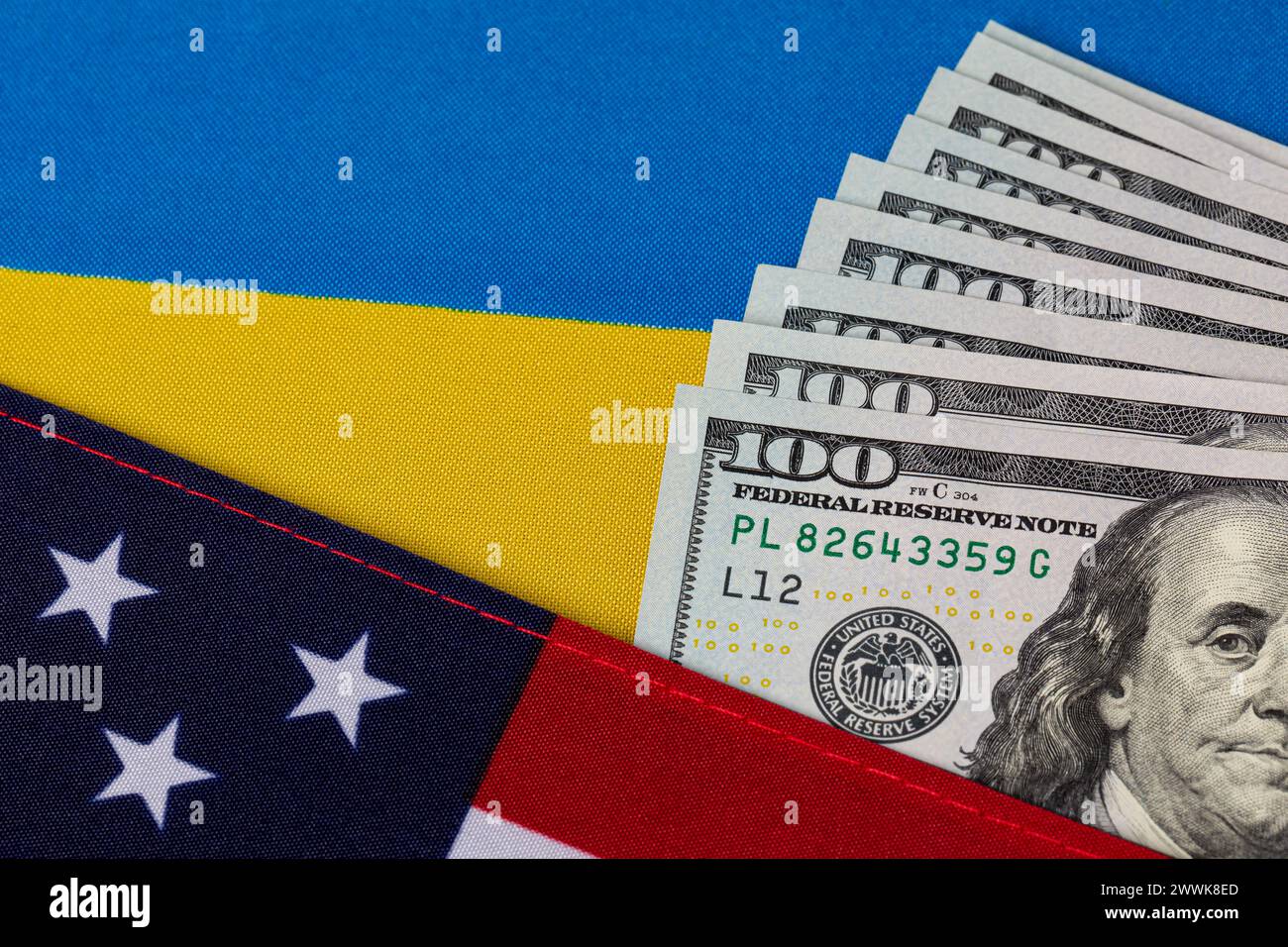 United States of America and Ukraine flags with cash money. Ukraine war financial support, foreign aid funding and military assistance concept. Stock Photo