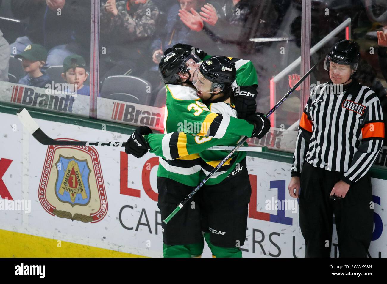 London, Canada. 24th Mar, 2024. The London Knights defeat the Guelph Storm 3-0 on the last game of the 2023-2024 season. Sam O’Reilly (23) of London Knights scores a much need empty net and gets hugs from Max McCue (39) of London Knights. (EDITORIAL ONLY) Credit: Luke Durda/Alamy Live News Stock Photo