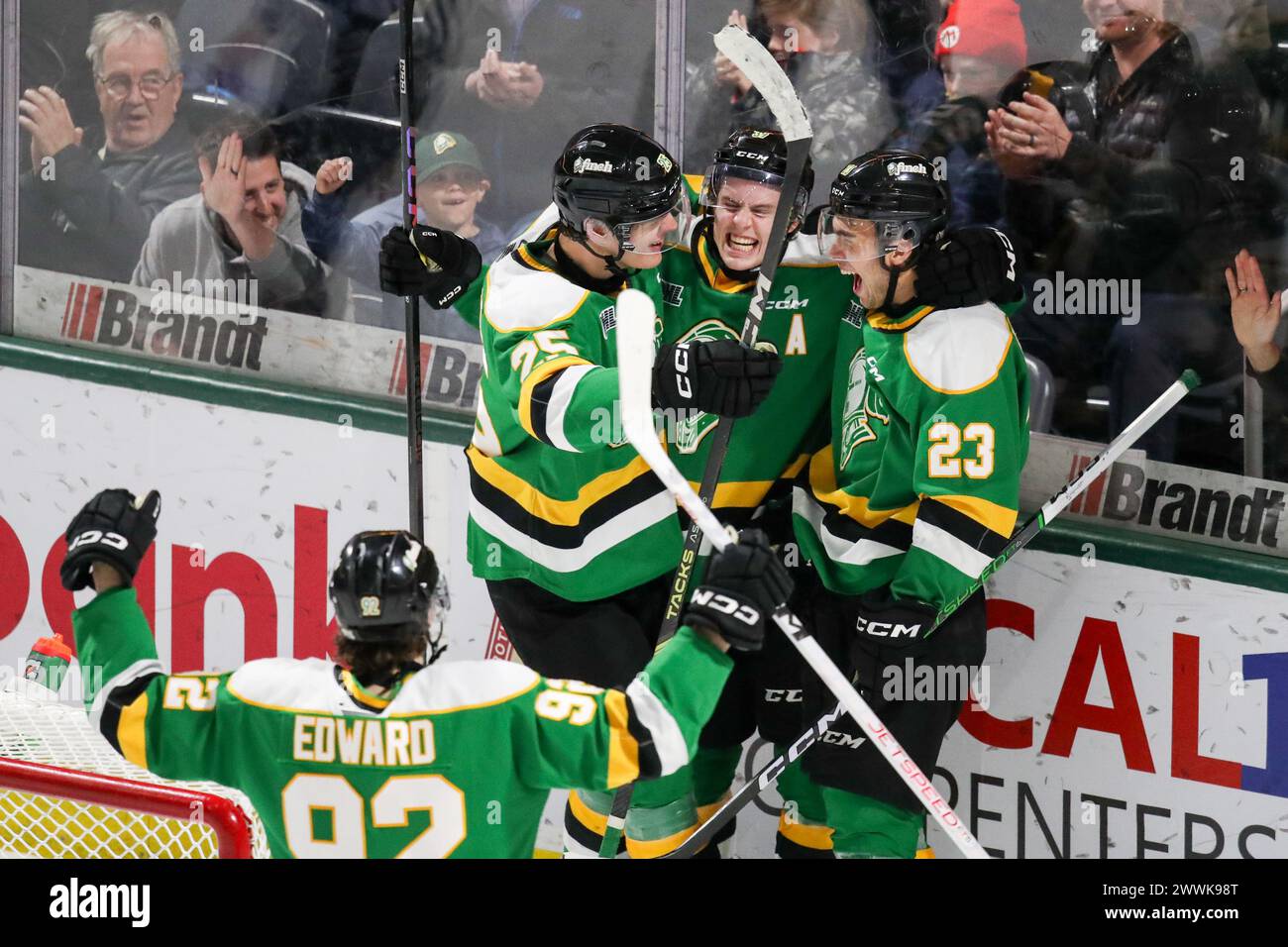 London, Canada. 24th Mar, 2024. The London Knights defeat the Guelph Storm 3-0 on the last game of the 2023-2024 season. Sam O’Reilly (23) of London Knights scores a much need empty net and gets hugs from Max McCue (39) and Kaleb Lawrence (25) of London Knights. (EDITORIAL ONLY) Credit: Luke Durda/Alamy Live News Stock Photo