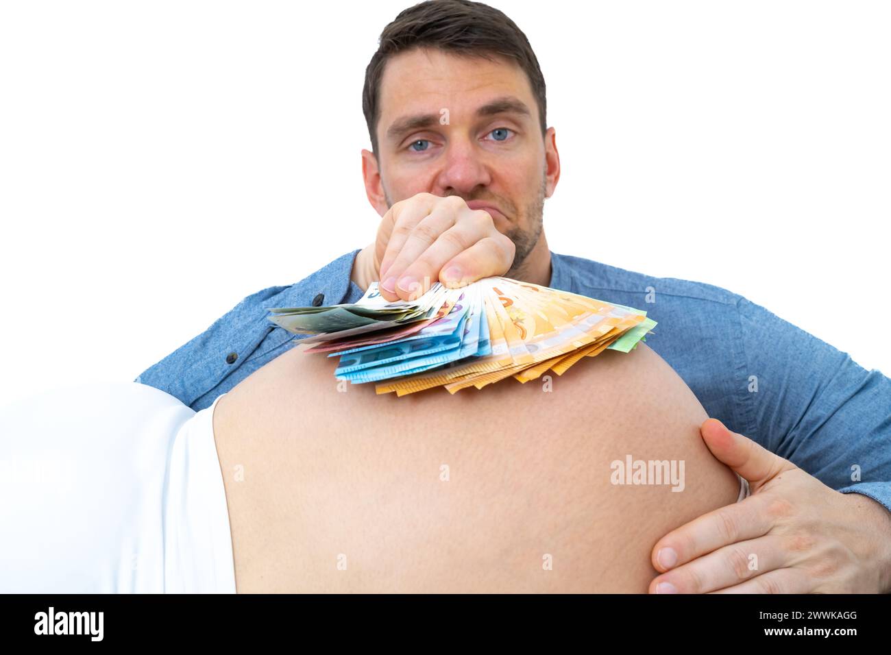 Description: Expectant father holds stack of big banknotes over ...