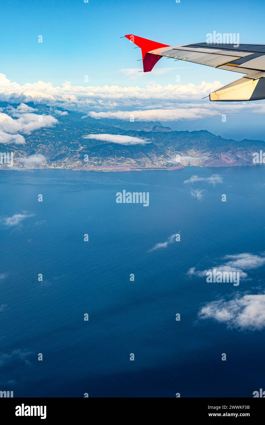 Description: Aerial view of the ocean, southeast coastline of Madeira Island, Funchal and the airport shat from an püassanger airplane. Madeira, Portu Stock Photo