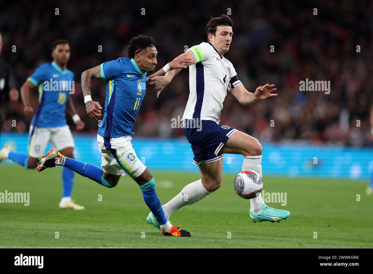 London, UK. 23rd Mar, 2024. Harry Maguire of England (r) & Raphinha of Brazil in action. England v Brazil, International football friendly match at Wembley Stadium in London on Saturday 23rd March 2024. Editorial use only. pic by Andrew Orchard/Andrew Orchard sports photography/Alamy Live News Credit: Andrew Orchard sports photography/Alamy Live News Stock Photo