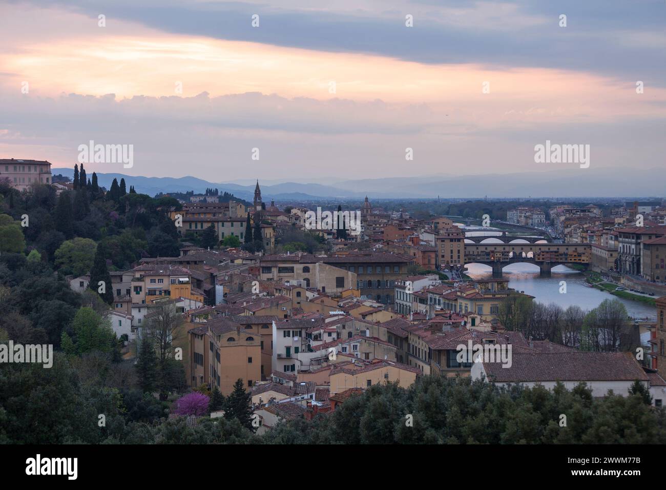 Sunset on Florence with in the background, the Basilica di Santo Spirito (English: Basilica of the Holy Spirit) and its spire, the Church of San Fredi Stock Photo