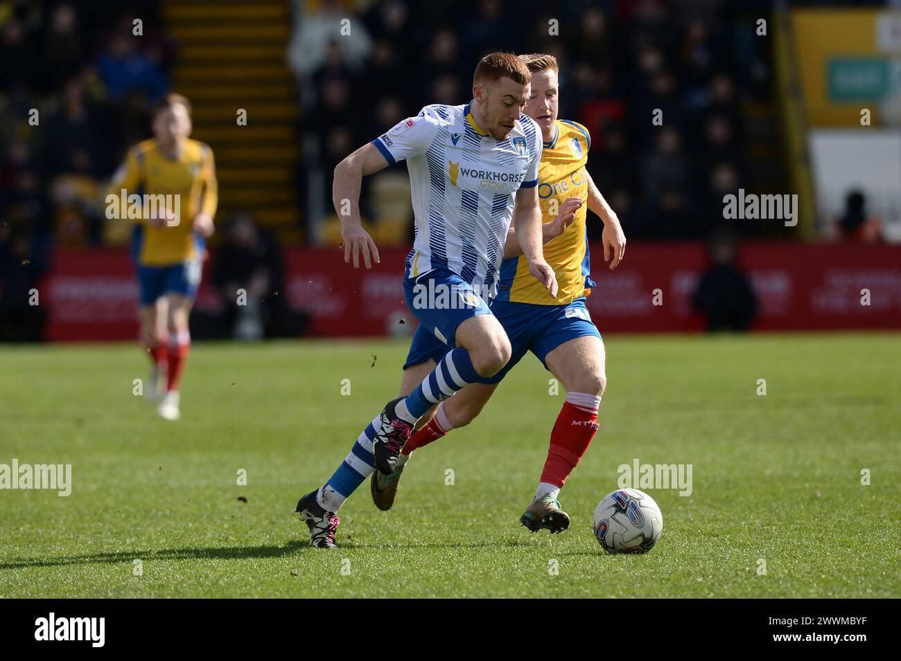 Arthur Read of Colchester United does battle with Davis Keillor-Dunn of Mansfield Town - Mansfield Town v Colchester United, Sky Bet League Two, One Call Stadium, Mansfield, UK - 23rd March 2024 Editorial Use Only - DataCo restrictions apply Stock Photo