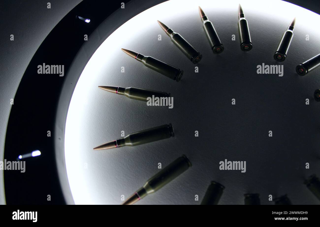 Assault Rifle Bullets Laid Out In Circle Order On White Surface Inside A Ring Lamp Stock Photo