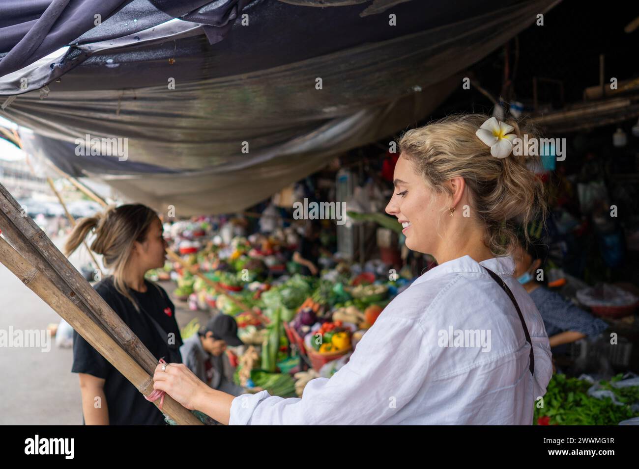Joyful Tourist Experiencing a Traditional Vietnamese Market Stock Photo
