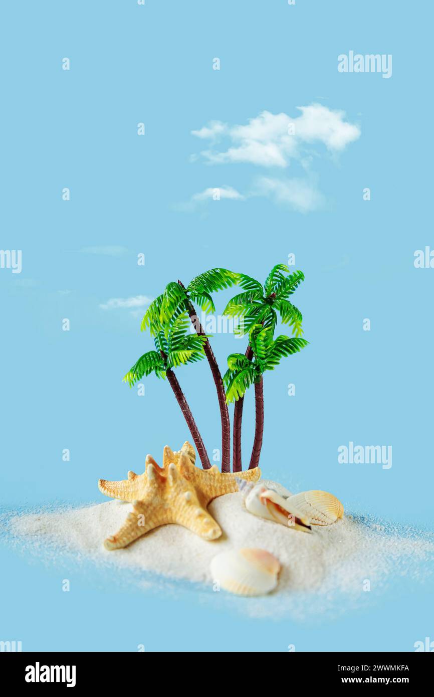 Island with palm trees, starfish and shells on a blue background. Tropical summer background. Free space for your decoration. Stock Photo