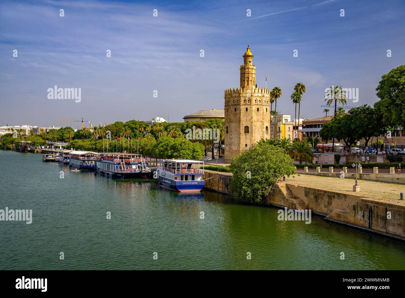 Traditional view of Seville with the Torre del Oro and the Guadalquivir river with some boats (Seville, Andalusia, Spain) Stock Photo