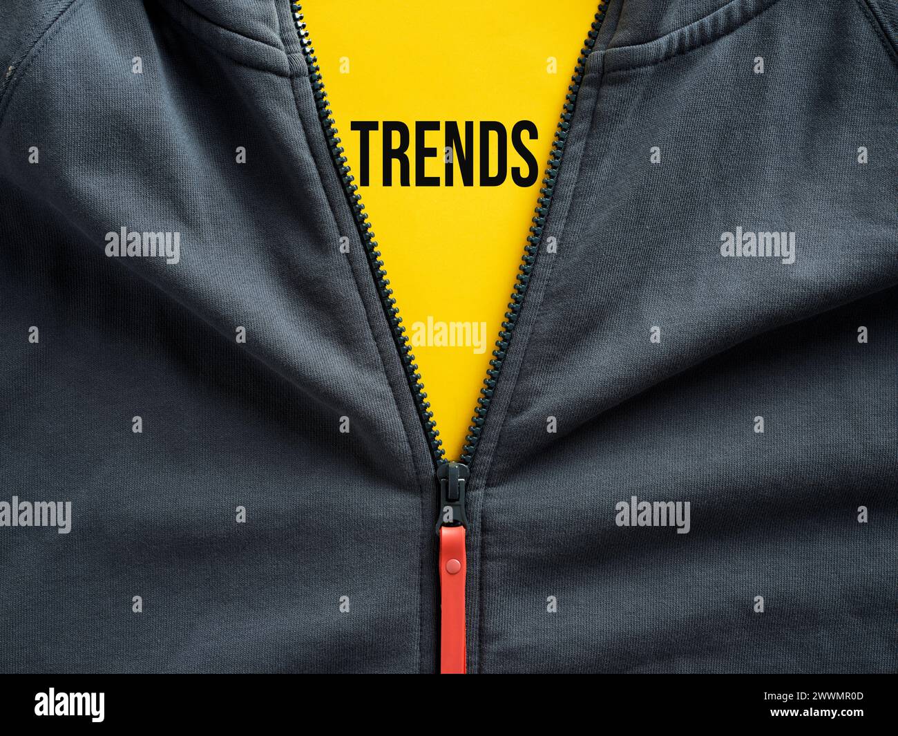 Opened zipper of a hoodie showing the word trends on a tag. Fashion trends in casual sportwear clothing. Stock Photo