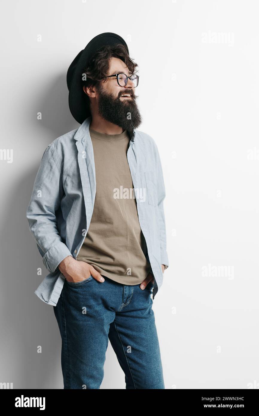 Stylish man with a beard wearing glasses and a hat Stock Photo - Alamy