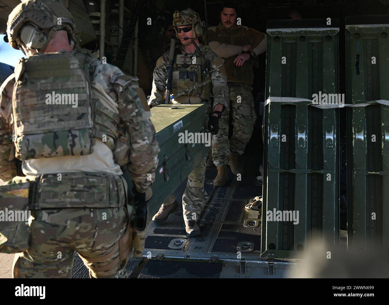 U.S. Airmen assigned to the 48th Rescue Squadron unload cargo during ...