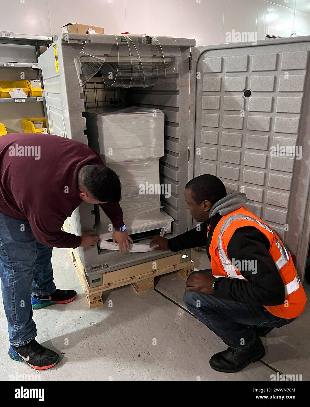 Workers at the U.S. Army Medical Materiel Center-Europe load a shipment of refrigerated medical items into a new cold-chain management container designed to hold temperatures between 2 and 8 degrees Celsius. The rugged, battery-powered units feature a self-regulated refrigeration system that can hold temperatures for 48 hours or more, ensuring medications, vaccines and other medical supplies reach their destination ready to be used. Stock Photo
