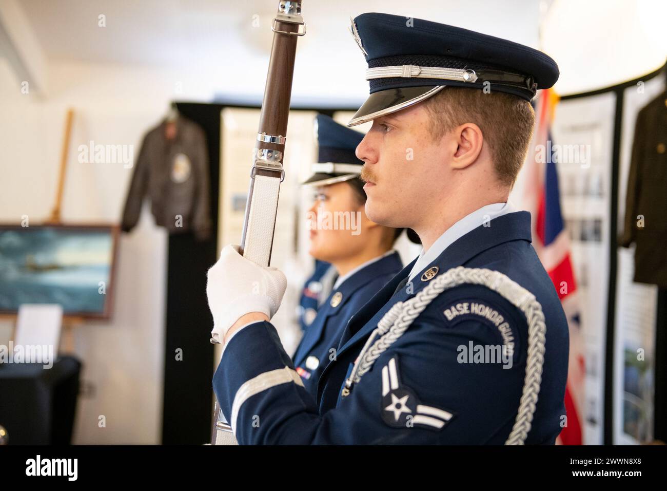U.S. Air Force Airman 1st Class Spencer Eagan, right, 501st Combat Support Wing Honor Guard team member, presents the colors during a Ceremony of Remembrance at Stanwick Lakes, England, Feb. 22, 2024. U.S. and U.K. leaders gathered to honor 17 Airmen who died in a midair collision on Feb. 22, 1944, involving B-17 Flying Fortresses from the 303rd Bombardment Group at RAF Molesworth and the 384th Bombardment Group at RAF Grafton Underwood. The Airmen were part of Operation Argument, or 'The Big Week,' targeting enemy industrial sites and aircraft facilities in Central Europe to secure Allied air Stock Photo
